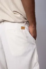 Bermuda color crudo de lino, con bolsillos laterales y traseros.