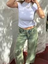 Pantalón jean de tiro alto con lavado ácido en tonos verde y azul.