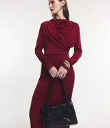 Vestido midi negro de manga larga, confeccionado en malla polyvelour, con cuello drapeado (degagê) y talle ajustado.