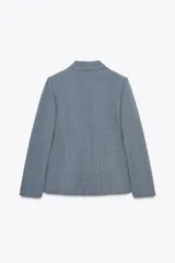 Blazer azul con cuello solapa y manga larga. Tiene un bolsillo de vivo en el pecho y cierre frontal con botones ocultos.