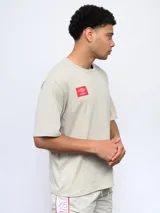 Remera color arena de corte holgado, con cuello redondo y logo de Umbro estampado en el pecho.