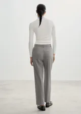 Pantalón de vestir gris de corte recto con pinzas, tiro medio, trabillas y cierre frontal oculto con botón, gancho y cremallera.