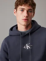 Buzo de felpa azul marino con capucha y cordones ajustables. Logotipo de Calvin Klein Jeans estampado en el pecho.
