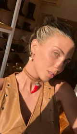 Gargantilla de cuero marrón con dije de cuerno rojo con incrustaciones de strass.