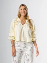 Blusa color amarillo pálido de algodón, con cuello mao y mangas 3/4 abullonadas con volados.