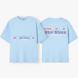 Camiseta celeste con estampado frontal y trasero con el texto "Ittai Stars" en color rojo y azul.