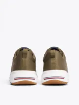 Zapatillas de running Tommy Hilfiger color verde oliva, con exterior de punto y poliéster, interior de poliéster, plantilla extraíble de goma termoplástica reciclada, suela de EVA dentada y trabilla para calzar.