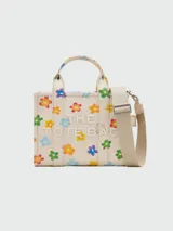 Bolso tote pequeño de lona color crema con estampado de margaritas de colores, doble asa superior y correa bandolera ajustable y extraíble.