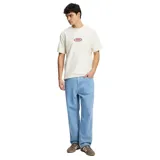 Remera color crema de manga corta con logo Rhythm estampado en el pecho.