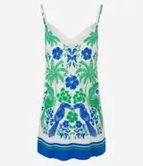 Vestido corto con breteles finos y escote en V, confeccionado en viscosa y lino. Presenta una estampa tropical con palmeras verdes, flores azules y dos aves azules enfrentadas. El ruedo tiene una franja azul con un detalle verde.