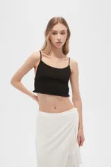 Musculosa negra de bretel fino, punto smock, al cuerpo, con reguladores y cuello redondo.