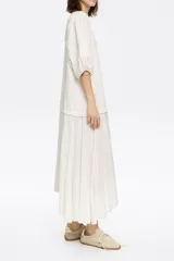 Vestido midi de corte línea A con vuelo, confeccionado en bimateria. Presenta escote caja, mangas cortas con volumen y detalles de encaje en las costuras de la falda. De fitting estándar.