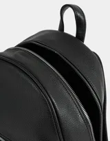 Mochila negra de cuerina con bolsillo frontal con cierre, correas regulables, manija superior, cierre superior y tag de metal.