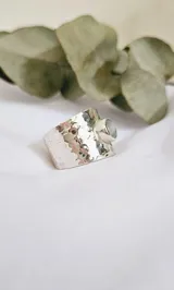 Anillo ancho de plata 925 con textura martillada y piedra luna redonda engarzada. Diseño artesanal y moderno.