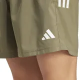 Short de running color caqui con logo Adidas estampado en blanco.