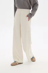 Pantalón negro de poliéster, de calce alto y corte ancho, con bolsillos laterales y cintura elástica.