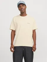 Camiseta de manga corta color crema, con cuello redondo y calce relajado. Presenta un pequeño logo de Jack & Jones estampado en el pecho y un estampado grande en la espalda.