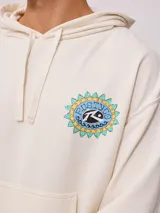 Canguro con capucha color crema, con bolsillo tipo canguro, puños y cintura acanalados. Estampado en el pecho con el logo de la marca y un diseño de sol.