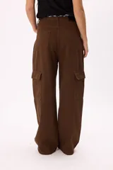 Pantalón cargo marrón de corte ancho con bolsillos laterales y cinturón de tela estampado.