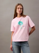 Remera rosa de algodón con cuello redondo y mangas cortas con dobladillo. Estampado de flor celeste en el frente y logo de Calvin Klein.