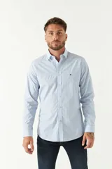 Camisa celeste a cuadros, de corte slim fit, manga larga y logo bordado. Confeccionada en 100% algodón.