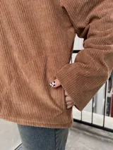 Campera marrón de pana con cierre frontal, cuello de piel sintética y bolsillos laterales.