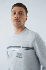 Buzo gris melange de algodón con cuello redondo, puños y cintura acanalados. Estampado frontal con el logo de la marca.