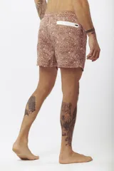 Short de baño estampado con motivos de hojas tropicales en tonos verde, beige y naranja.