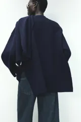 Abrigo azul marino de punto con cuello redondo y manga larga. Incluye bufanda integrada y cierre frontal con botón.