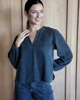 Blusa de mezclilla de manga larga, con elástico en los puños y cuerpo más largo.