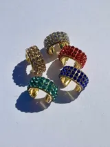 Aro tipo earcuff dorado con incrustaciones de strass de colores.