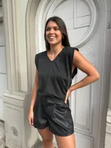 Blusa negra de lurex con hombreras y escote en V.