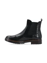 Botín de caña corta color negro, de origen europeo, con combinación de materiales: cuero croco, cuero snake y cuero nobuk. Presenta elásticos laterales al tono y forro de pelo sintético.