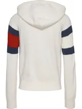 Sweater con capucha de punto color crema, con cierre frontal y mangas largas. Presenta bloques de color azul marino y rojo en las mangas, y logo de Tommy Jeans bordado en el pecho.
