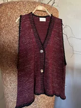 Chaleco tejido a mano con escote en V, bordado con botones, confeccionado en algodón con detalles de lurex. Terminaciones en crochet y bordados hechos a mano con lana merino.