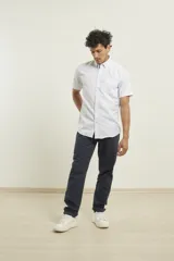Camisa blanca de manga corta con estampado de lunares pequeños en azul.