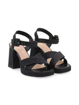 Sandalias de cuero color canela con plataforma y tacón ancho. Tiras cruzadas en el empeine y pulsera ajustable con hebilla en el tobillo.