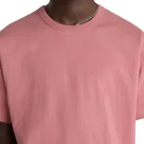 Remera lisa color rosa con logo Vans Off The Wall estampado en el pecho.