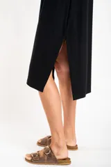 Vestido midi negro de viscosa con elastano, corte recto y mangas cortas.