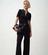 Pantalón femenino de punto roma color azul marino, de corte recto, con pliegues frontales y bolsillos laterales.