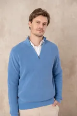 Sweater azul de algodón pigmentado con medio cierre y cuello alto.