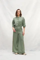 Pantalón verde oliva de lino, corte jeanero, bolsillos plaque traseros y cintas a contratono en los laterales.