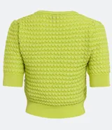 Blusa negra de manga corta con cuello redondo y textura de punto con patrón de corazones o escamas.