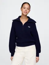 Sweater azul marino de tejido de punto grueso, con cuello polo con cierre de media cremallera y logo bordado en el pecho.