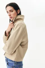 Campera color beige de corte holgado en sarga de algodón. Modelo con cuello, cierre de botones y bolsillos parche delanteros.