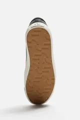 Zapatillas blancas de cuero con detalles en gamuza en la puntera y el talón. Cierre con cordones.