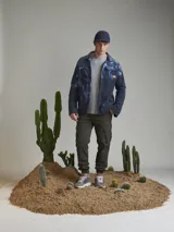 Pantalón cargo negro con bolsillos laterales con solapa, corte ajustado y tobillos elastizados.