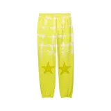 Pantalón de jogging amarillo con estampado de cuadrados y estrellas blancas.