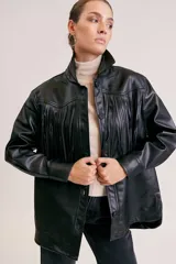 Campera negra simil cuero con flecos en el frente, cuello clásico, cierre con botones a presión y corte holgado.