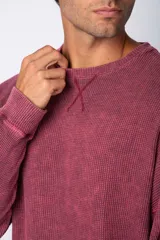 Buzo de hombre de corte oversize confeccionado en tela waffle de algodón con proceso de teñido acid en color borgoña.